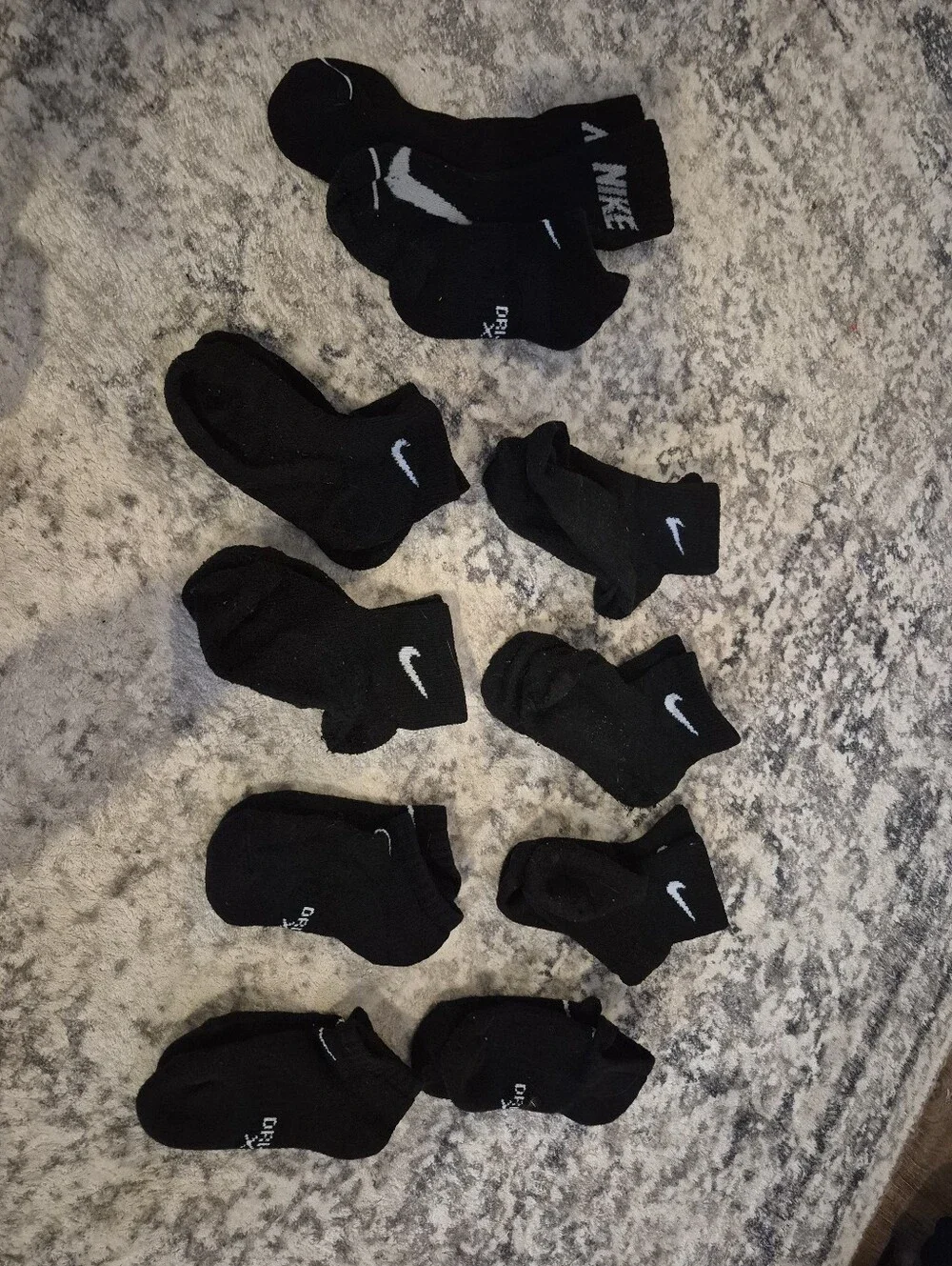 8 pairs of Nike black xs socks and 3 extra no matches socks